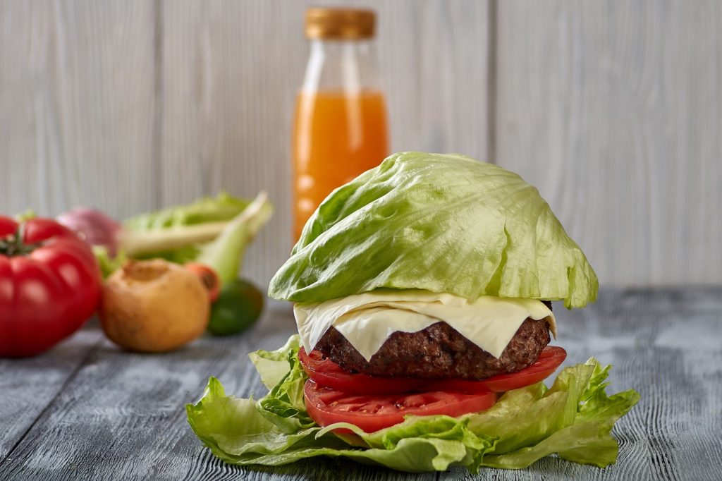A burger with lettuce leaves used instead of the rolls to represent a diet a diabetic may be on.